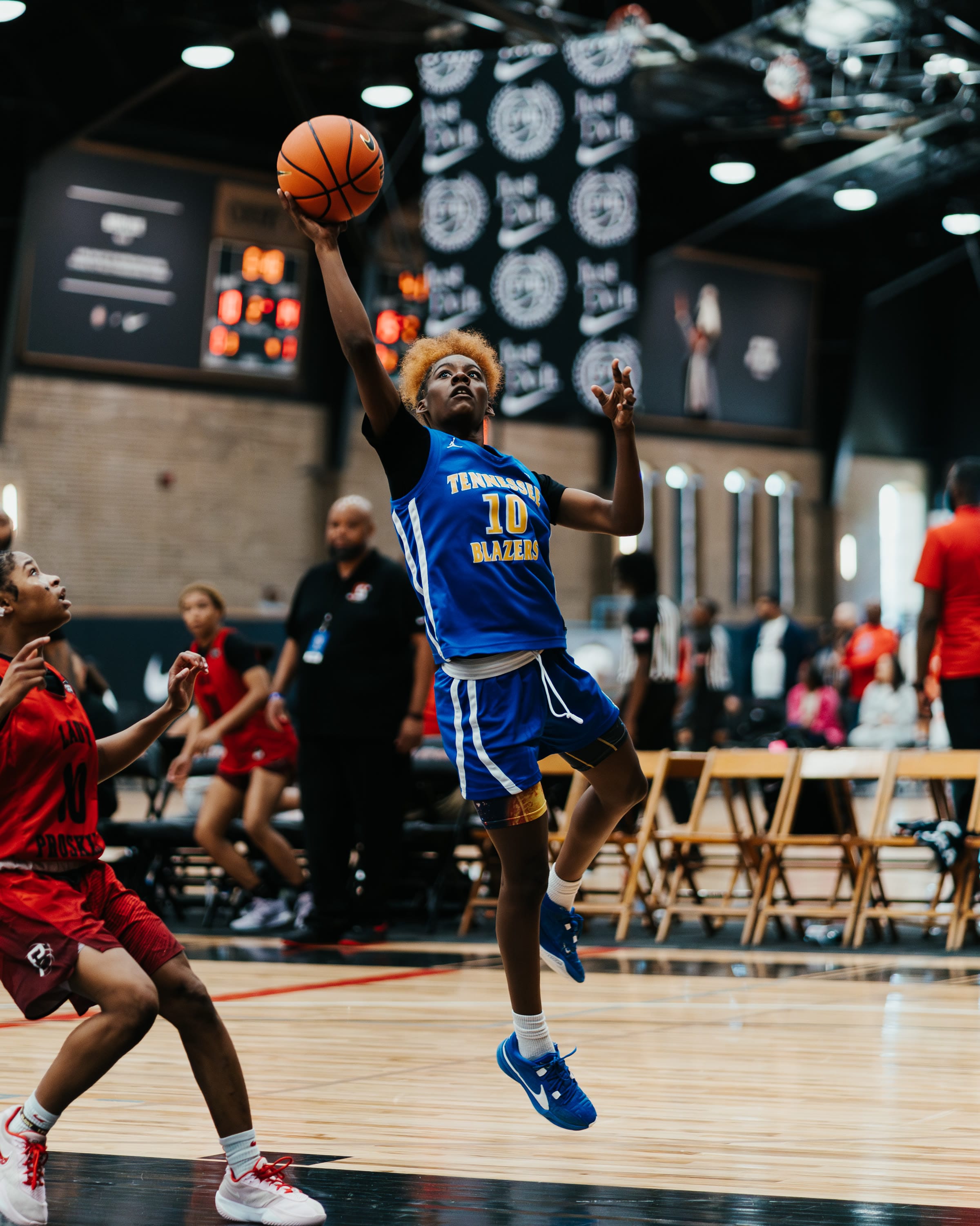 Basketball player contesting a shot at an EYBL tournament