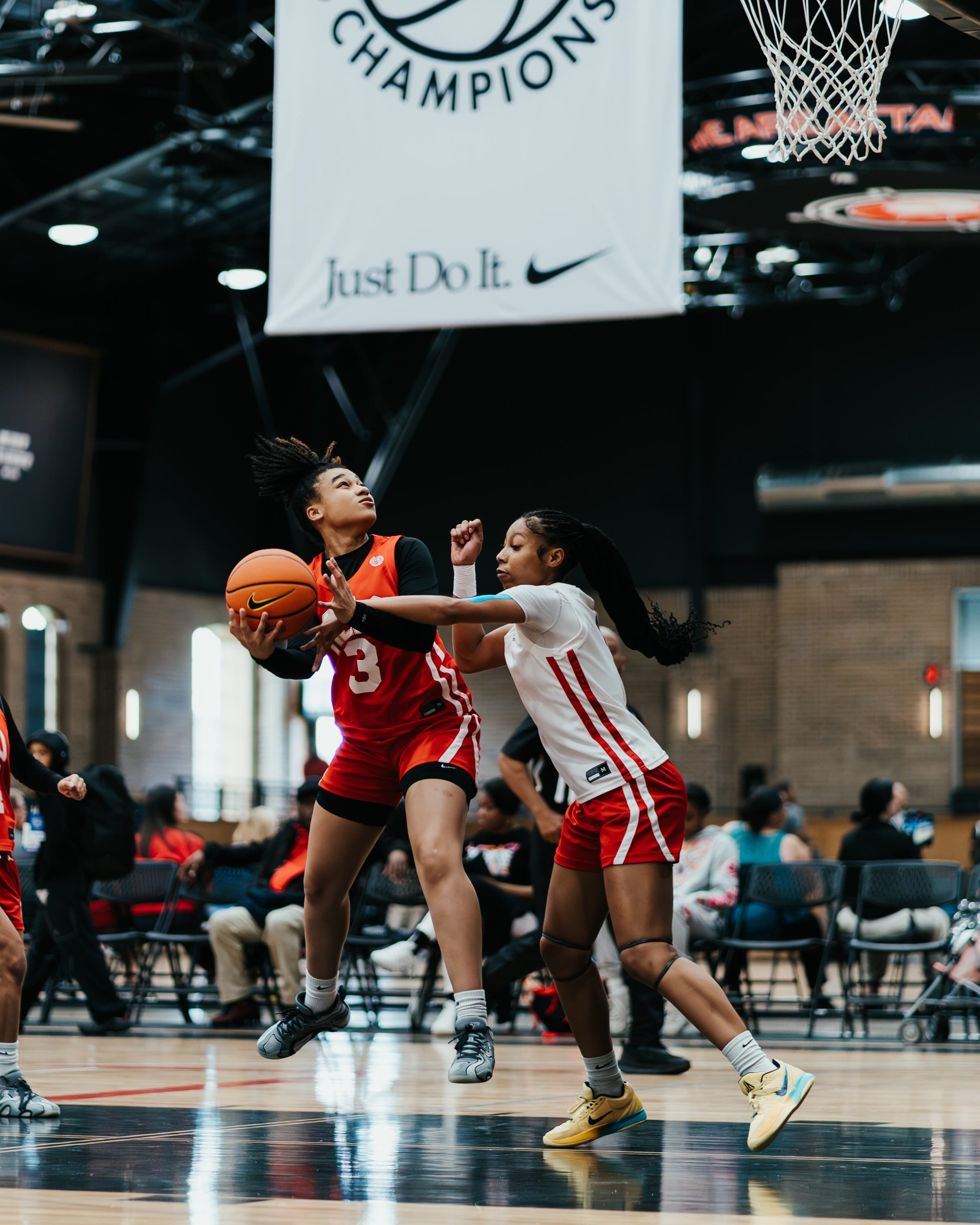 Basketball player driving to the basket at an EYBL tournament