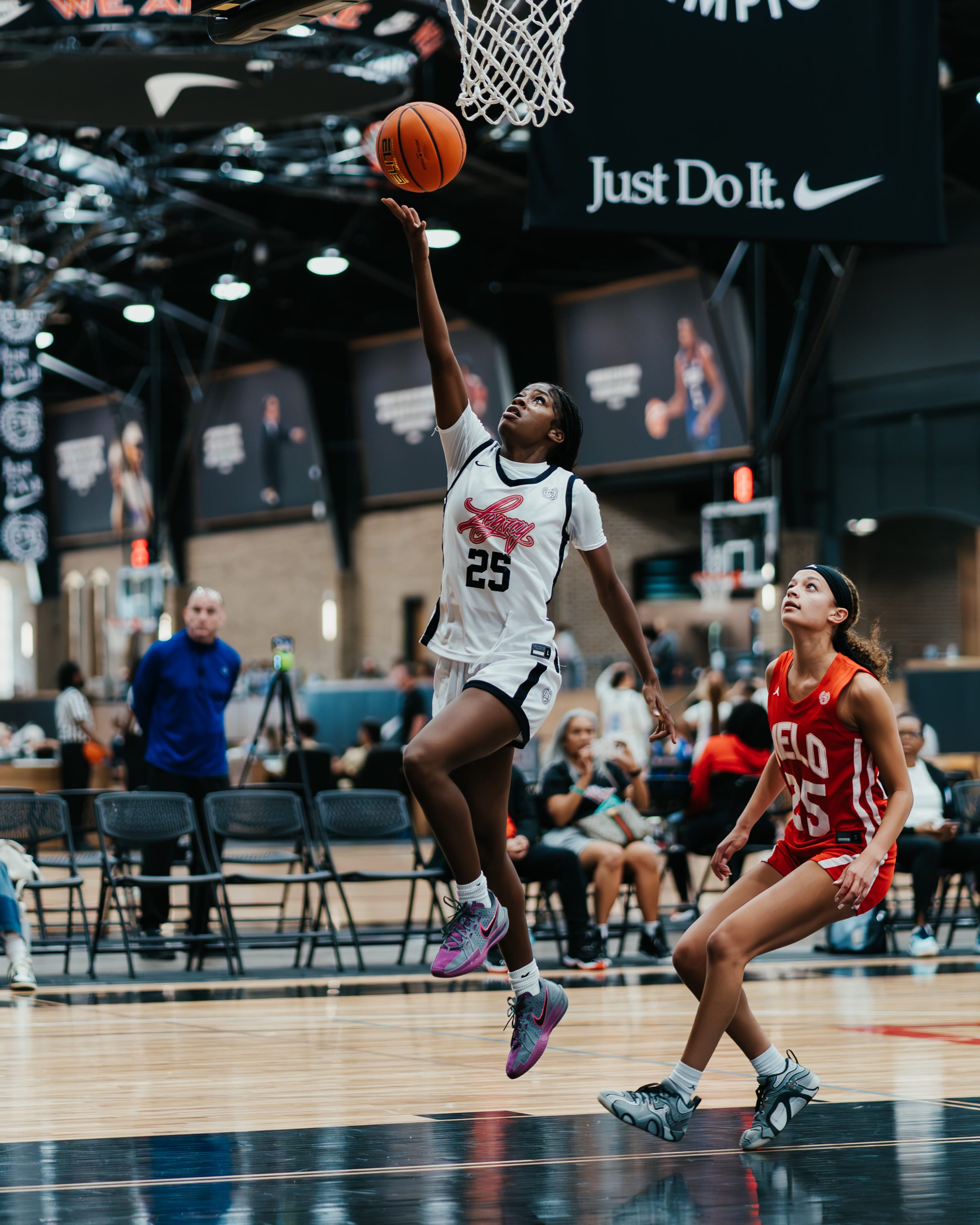 Basketball player going up for a layup at an EYBL tournament