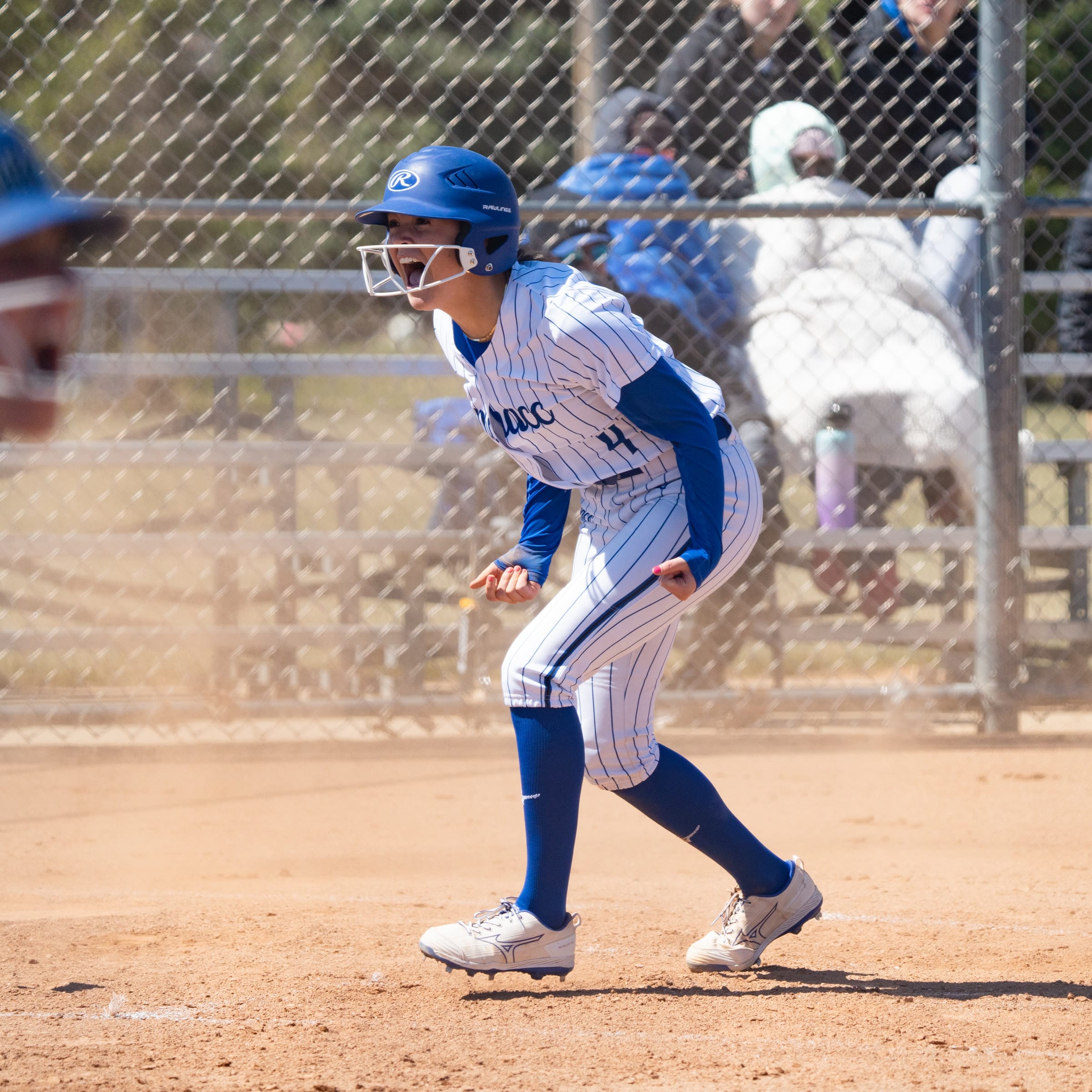 Softball player celebrating while running the bases