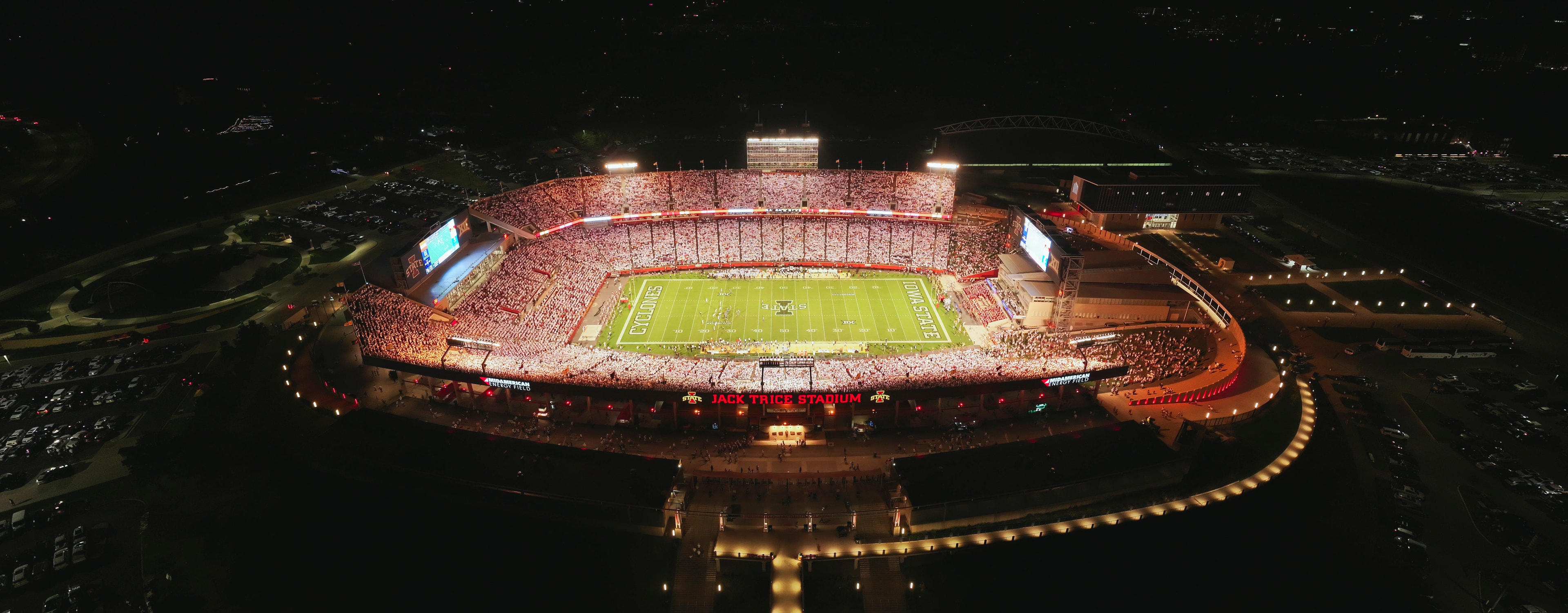 Aerial night view of a packed Jack Trice Stadium during a card stunt